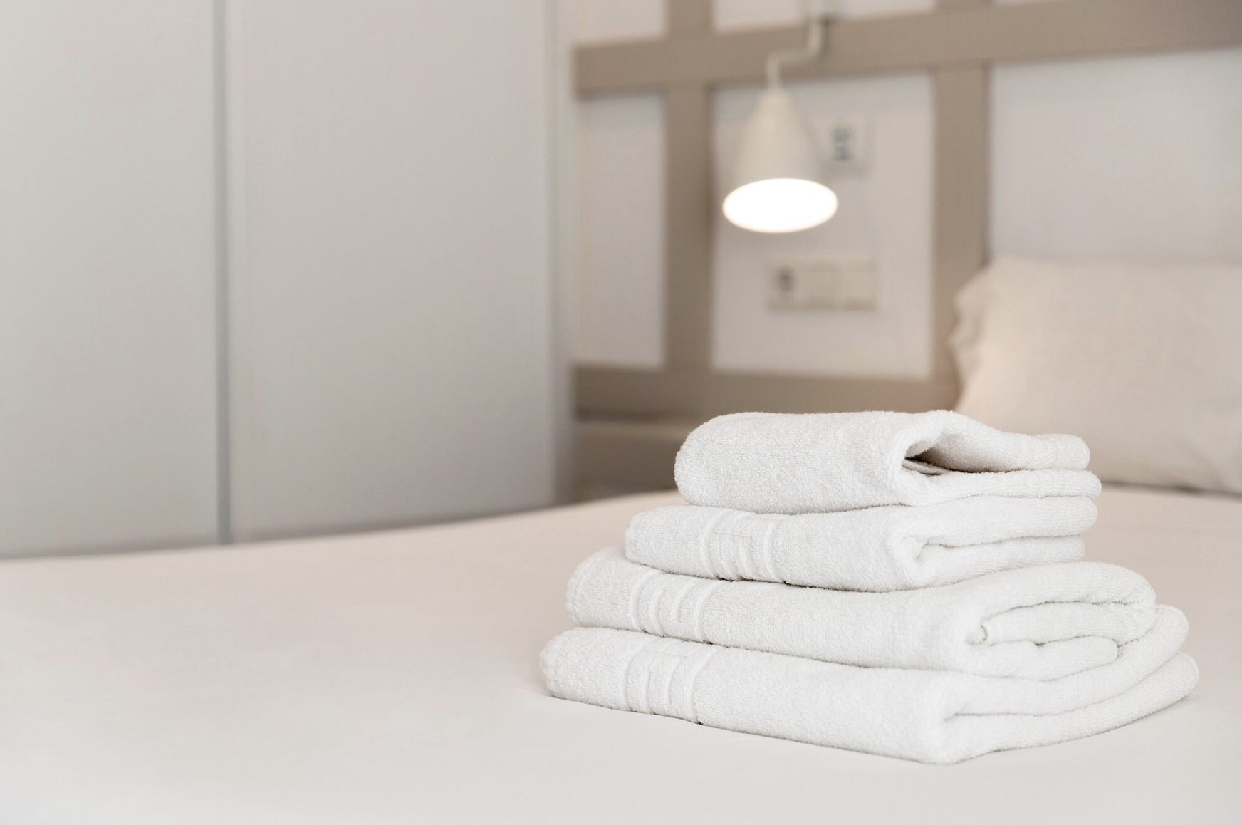 Folded towels on a bed at Alfanar Palace Hotel